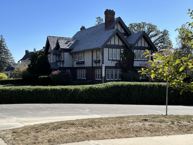 exterior space with stucco siding and a chimney