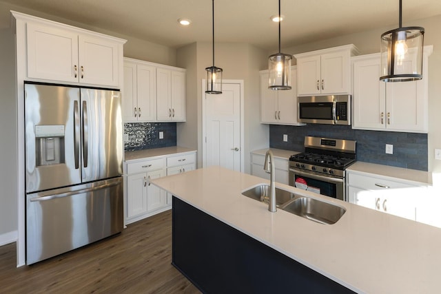 kitchen featuring hanging light fixtures, white cabinets, and stainless steel appliances