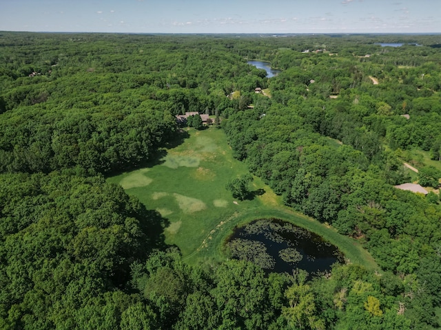 aerial view with a wooded view and a water view