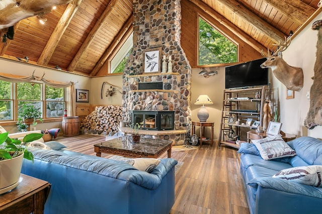 living room with a stone fireplace, wooden ceiling, wood-type flooring, and beam ceiling