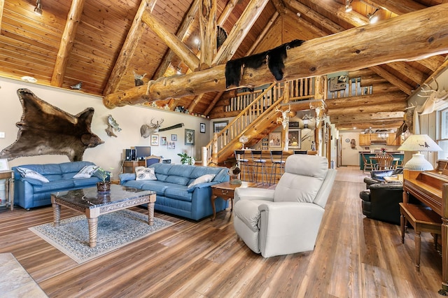 living room featuring beamed ceiling, wooden ceiling, stairs, and wood finished floors