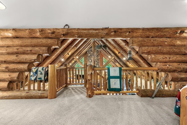 interior space with vaulted ceiling, carpet floors, and log walls