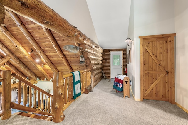 hallway with high vaulted ceiling, log walls, beam ceiling, wooden ceiling, and carpet flooring