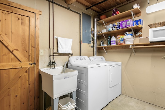 laundry area featuring separate washer and dryer and a sink