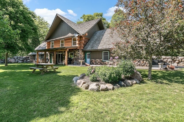 back of property featuring stone siding, a lawn, log exterior, and a patio