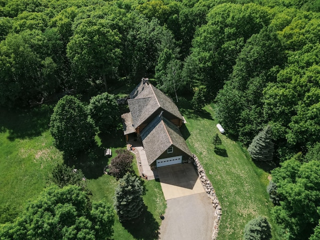 drone / aerial view featuring a wooded view