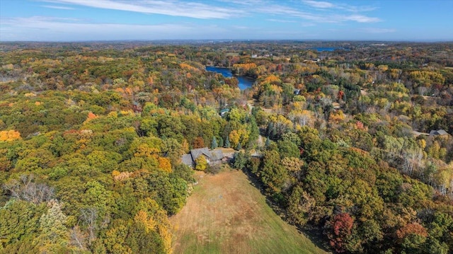 birds eye view of property with a forest view and a water view