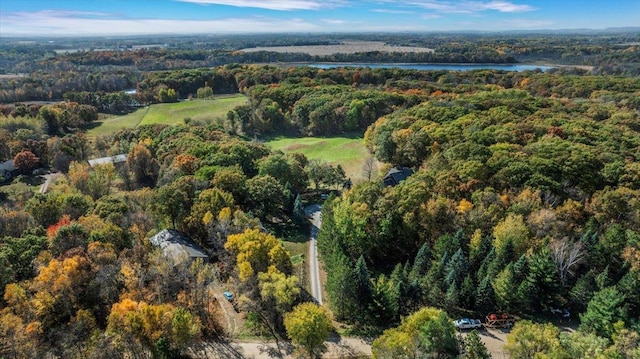 drone / aerial view with a forest view and a water view