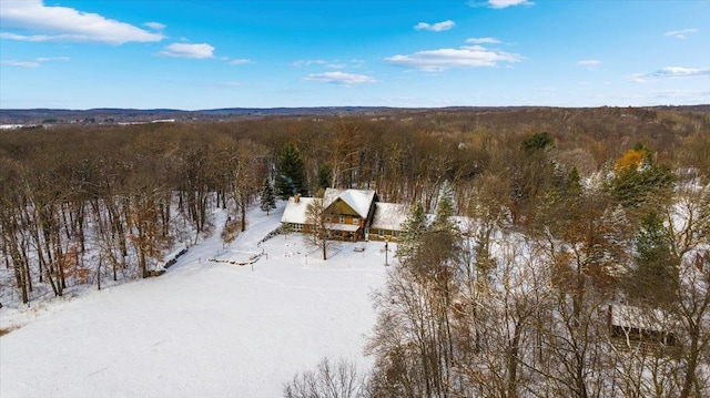 snowy aerial view featuring a view of trees