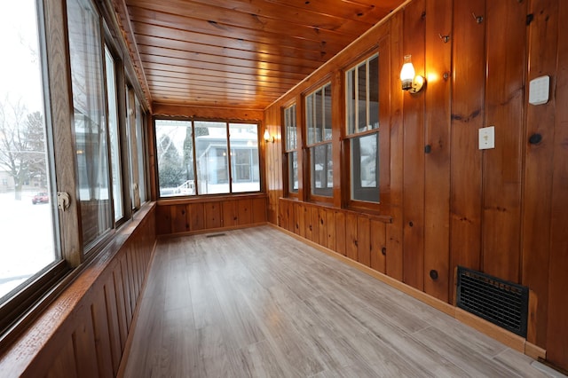 unfurnished sunroom with wooden ceiling