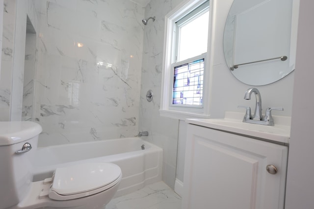 full bathroom featuring vanity, tiled shower / bath combo, and toilet