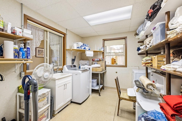 washroom with washer and dryer, cabinets, and sink