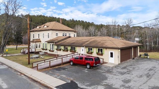 view of front of house with a garage and a wooden deck