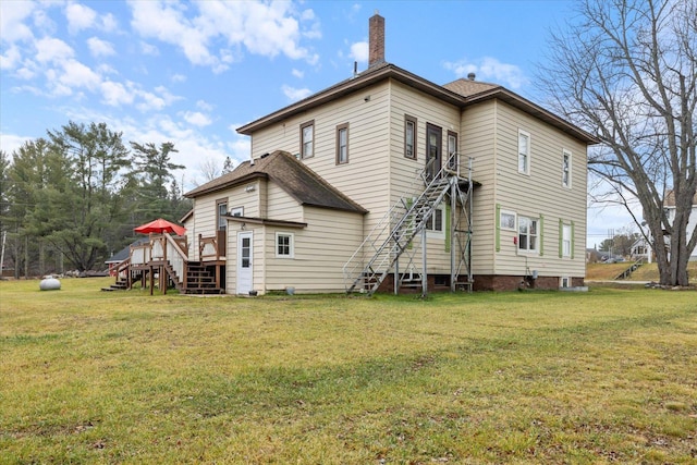 back of house with a lawn and a wooden deck