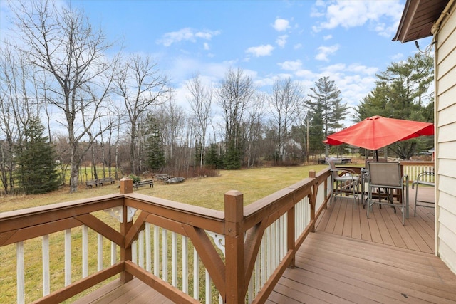 wooden terrace featuring a lawn