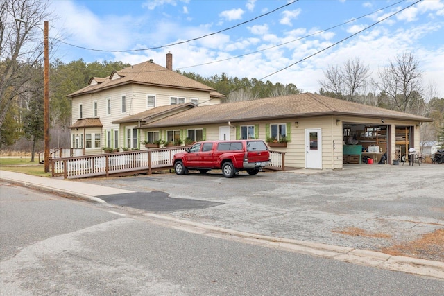 view of front of house featuring a garage and a deck