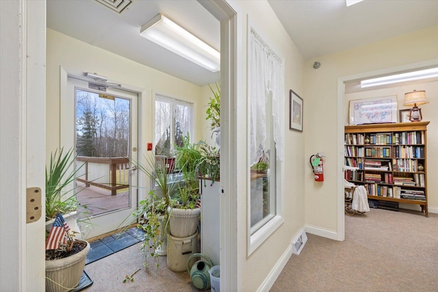 doorway featuring light colored carpet