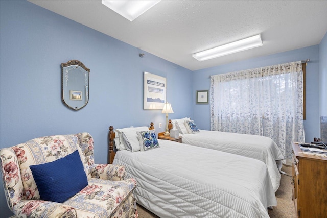 carpeted bedroom featuring a textured ceiling