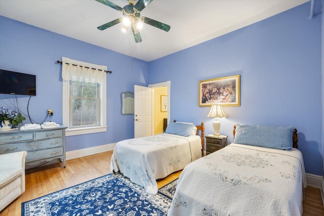 bedroom featuring hardwood / wood-style floors and ceiling fan