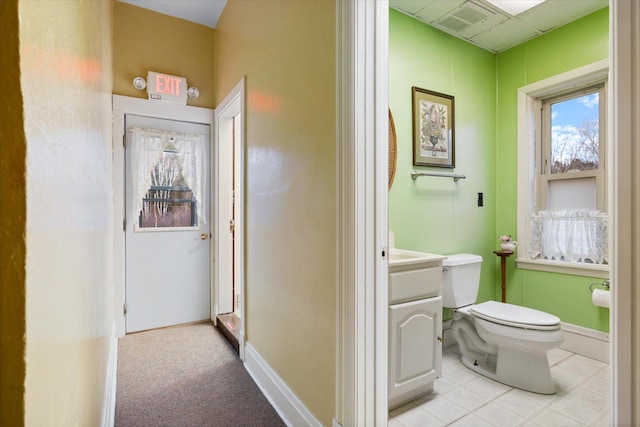 bathroom with tile patterned floors, vanity, and toilet