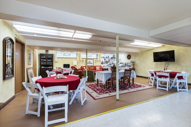 dining space featuring concrete flooring