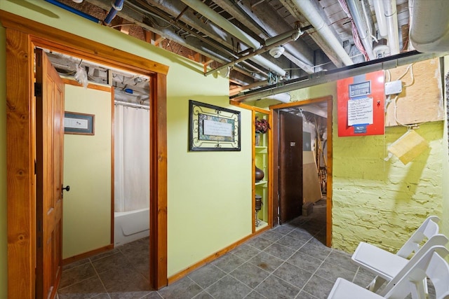 corridor featuring dark tile patterned floors