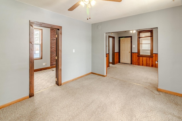 carpeted empty room with ceiling fan