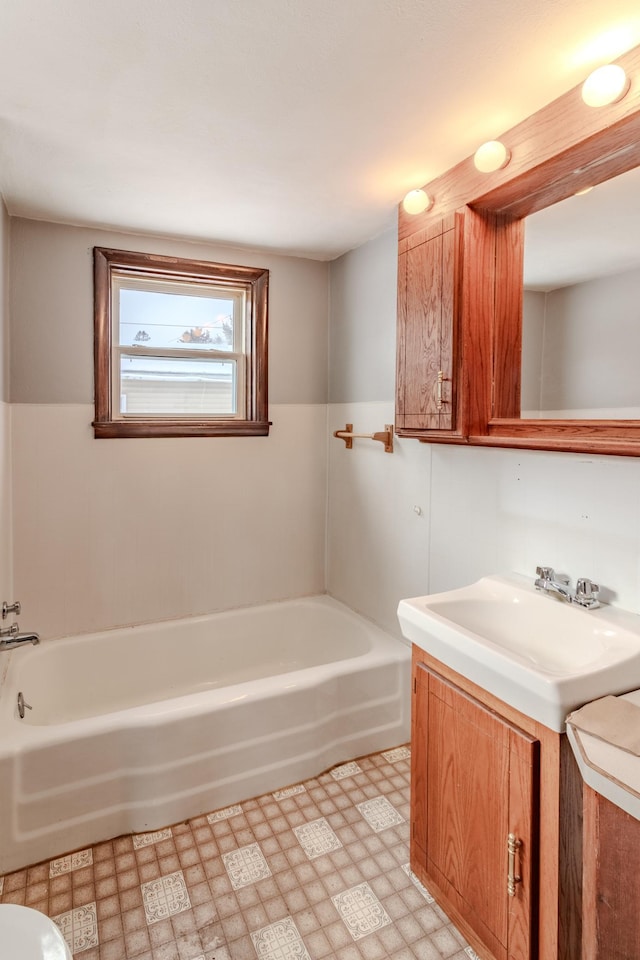 bathroom with vanity and a tub