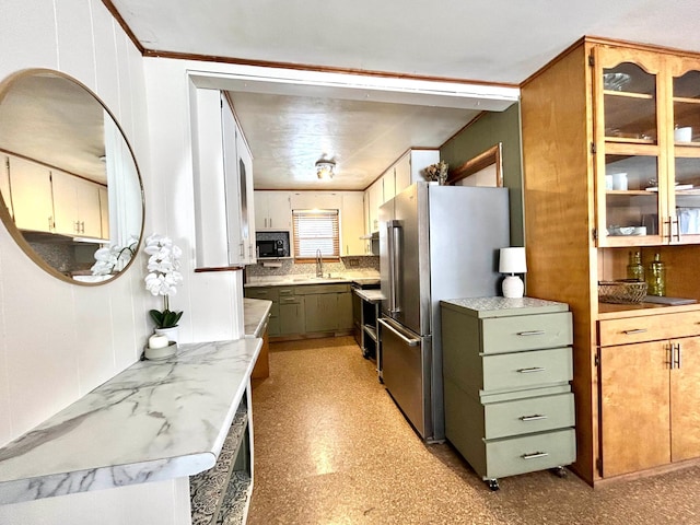 kitchen featuring high end fridge, sink, and green cabinetry