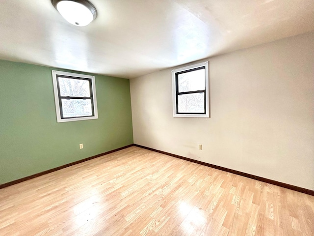 unfurnished room with a wealth of natural light and light hardwood / wood-style floors