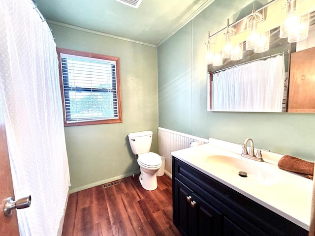 bathroom featuring vanity, toilet, wood-type flooring, and crown molding