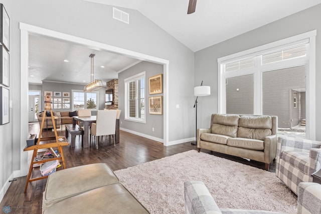 living room with ceiling fan, dark hardwood / wood-style flooring, lofted ceiling, and crown molding