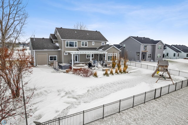 snow covered property with a jacuzzi