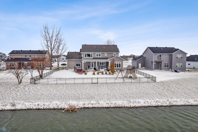 back of property with a water view