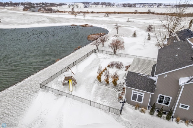 snowy aerial view featuring a water view