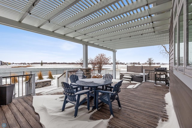 snow covered deck featuring a pergola