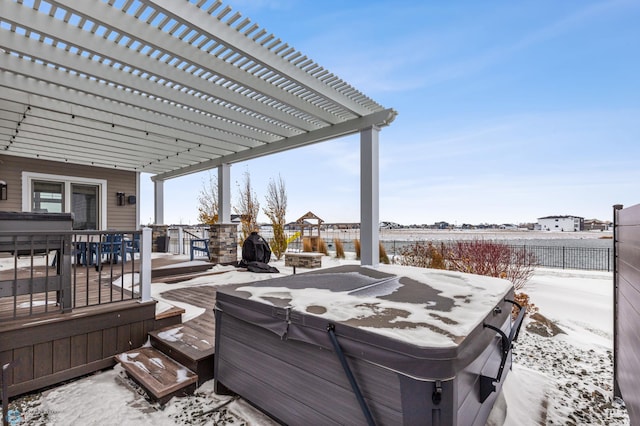 snow covered deck with a pergola and a hot tub