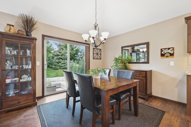 dining area featuring an inviting chandelier and dark hardwood / wood-style floors