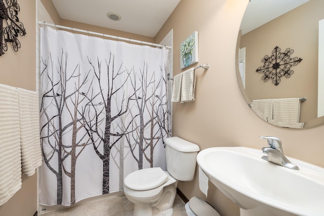 bathroom featuring toilet and sink