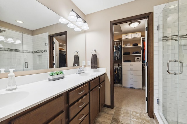 bathroom with vanity and a shower with door