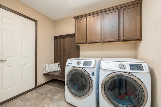 washroom featuring cabinets and washer and dryer