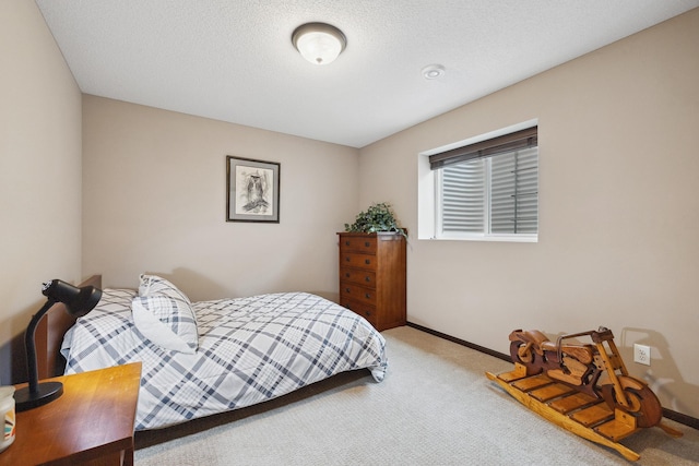 bedroom featuring carpet flooring and a textured ceiling