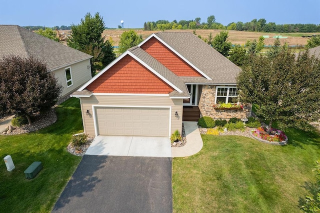 craftsman inspired home featuring a garage and a front lawn