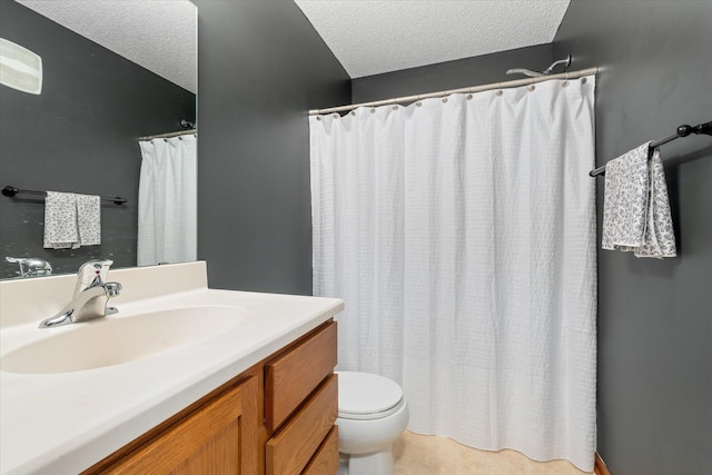 bathroom featuring vanity, a textured ceiling, and toilet