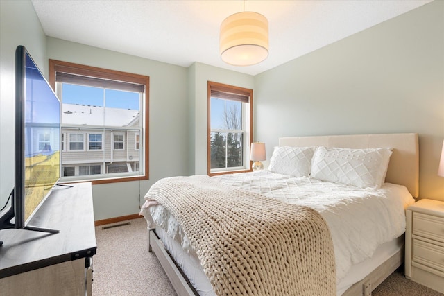 carpeted bedroom with multiple windows