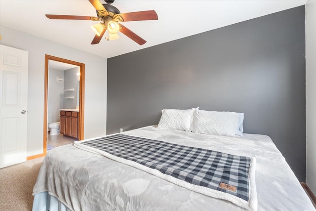 bedroom featuring connected bathroom, light colored carpet, and ceiling fan