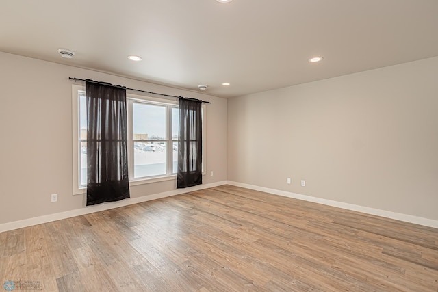 spare room with light hardwood / wood-style floors