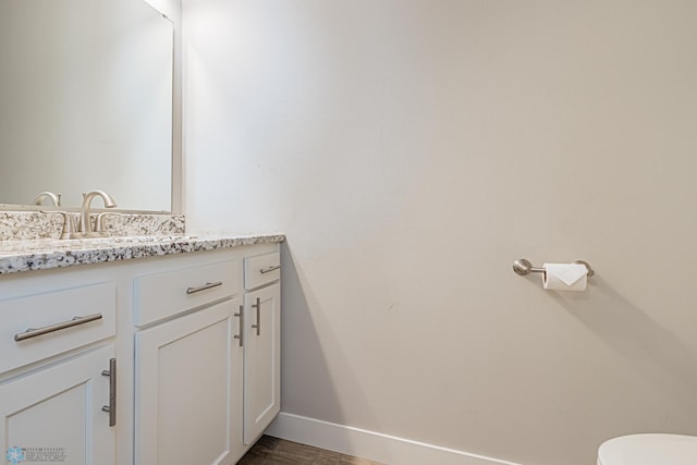 bathroom with hardwood / wood-style flooring and vanity