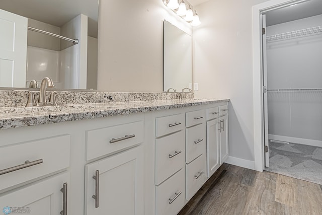 bathroom with vanity and hardwood / wood-style flooring