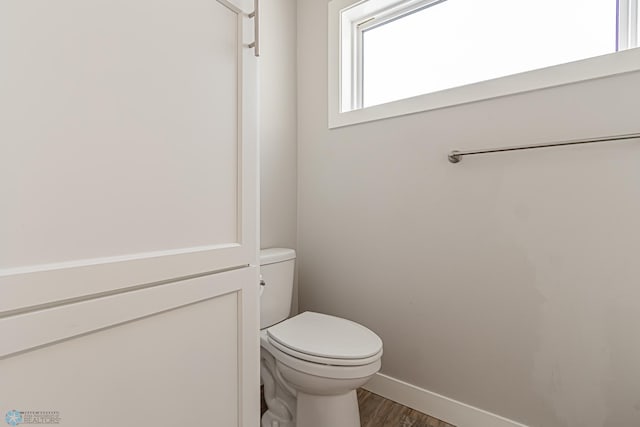 bathroom featuring hardwood / wood-style floors and toilet